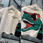 Short-Sleeved T-shirt - Crisp white base with "FANTASTIC I BELL" printed on the front chest and  a teal and red dinosaur graphic