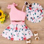 Floral Summer Set - Soft pink one-shoulder crop top with a bow and high-waisted floral skirt and a wide-brimmed sun hat