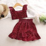 The Ruby Retro Dot Set - A cute maroon and white polka dot set featuring a ruffled top and matching tiered ruffle skirt