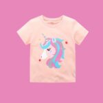 The Pastel Unicorn Magic Tee - A comfy peach-pink cotton t-shirt featuring a colorful graphic unicorn print with star accents