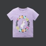 The Lavender Wreath Unicorn Tee - A vibrant lavender-purple cotton t-shirt featuring a majestic unicorn graphic framed by a colorful floral wreath