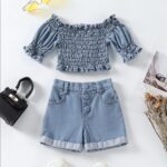 Sky Blue Buttoned Denim Set - A light-blue denim set featuring an off-the-shoulder smocked top and button-front cuffed shorts