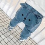The Little Bear Cotton Joggers - Cute light-blue cotton baby pants featuring a playful 3D bear face and ears on the back