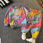 The Graffiti Teddy Jogger Set - A multicolored paint-splatter tracksuit featuring a cute teddy bear graphic on the sweatshirt